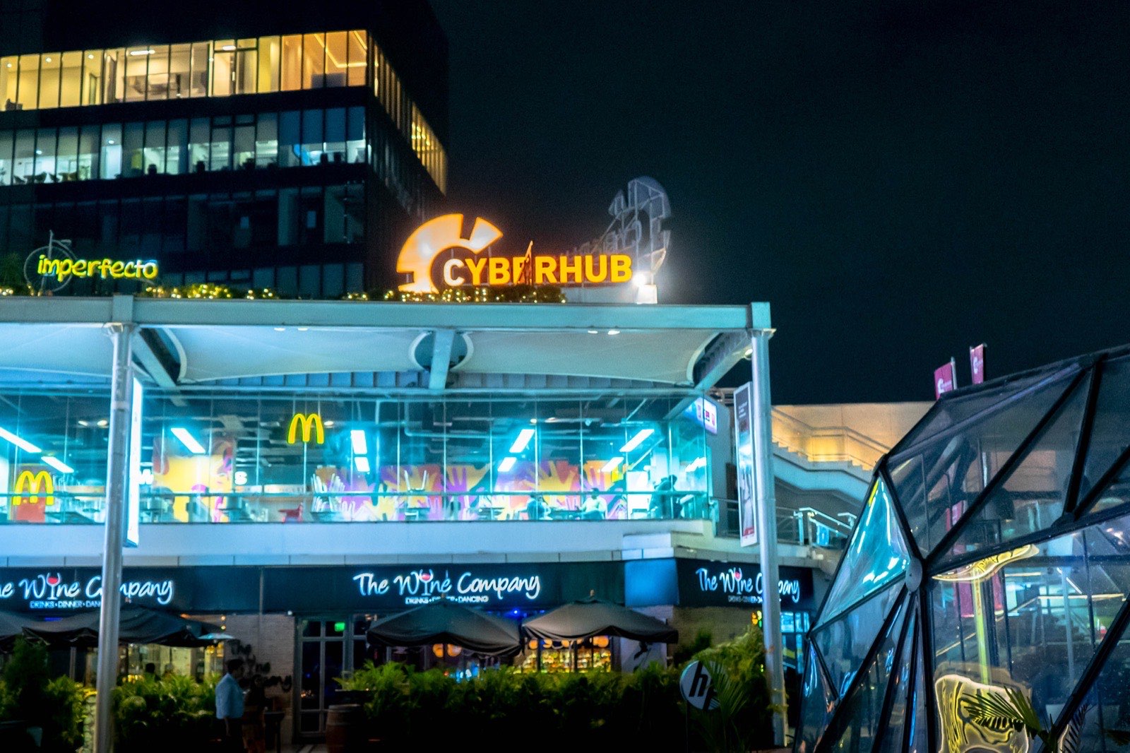 Restaurants lit up in the evening at CyberHub, Gurugram