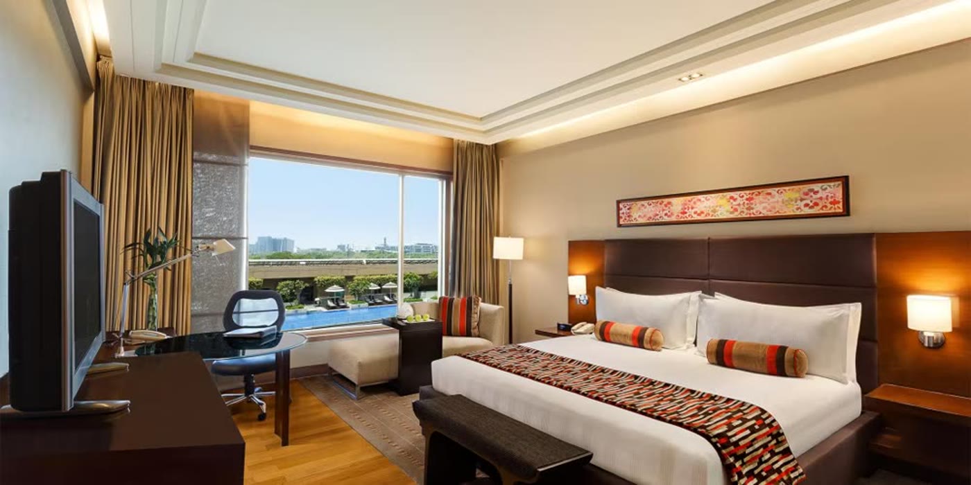 A deluxe room with a pool view at Crowne Plaza, Gurgaon